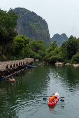 Luxurious mountain with vegetation and a lake with wooden hut and canoe kayak, Thakhek loop, Laos
