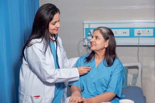 Indian female doctor using a stethoscope for check up on bed at hospital. - Powered by Adobe