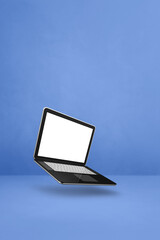 Floating computer laptop isolated on blue. Vertical background