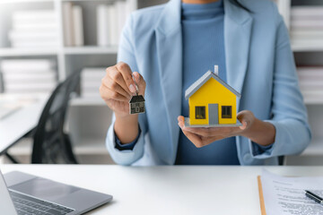 Female employee offering homes to client with contract and insurance. Real estate agent offering house or condo to client and contract and insure.