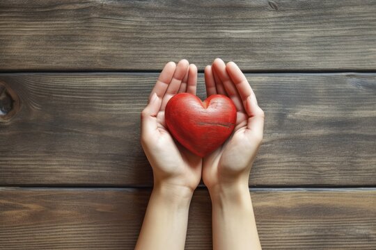 Hand hold red heart on brown background. Concept donation helps find loving health care equity and promote well being. International Mother's Day. Generative AI