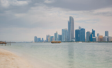Obraz premium Beautiful view of the skyscrapers of Abu Dhabi over cloud sky before rain.