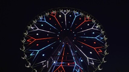 Ferris wheel at night. Ferris wheel in motion in an amusement park at night. High quality 4k footage