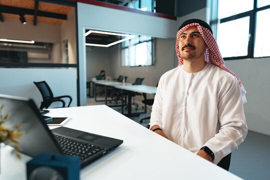 Successful muslim businessmen in traditional outfit in his office