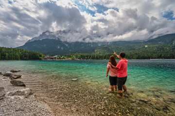 Zugspitze Peak top of Germany Alps mountain range and Eibsee Lake with lover couple tourist,...