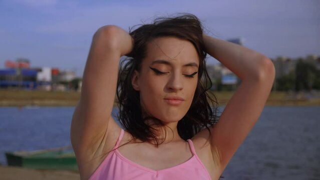 Girl posing on the beach. A beautiful Schumann walks on the sand. Shuman and bikini.