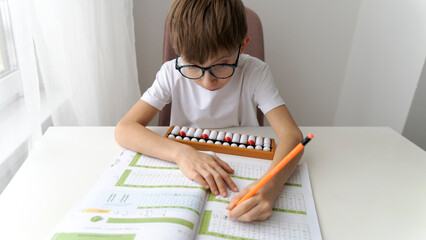 The boy is engaged in abacus, mental arithmetic for children