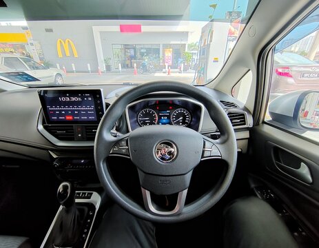 A picture of Malaysia Proton Tiger Logo at steering wheel with car interior