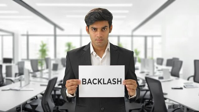 Angry Indian manager holding BACKLASH banner
