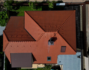 Fototapeta na wymiar checking the cleanliness of the chimney using a drone. Cleanliness is essential for safety and the risk of soot ignition. a drone equipped with a camera inspects high on the roof. chimney work, red