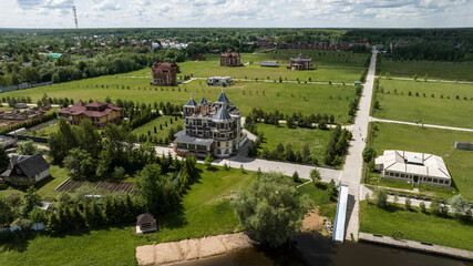 panoramic view of the river and coastal forest and houses on a summer day shot from a drone