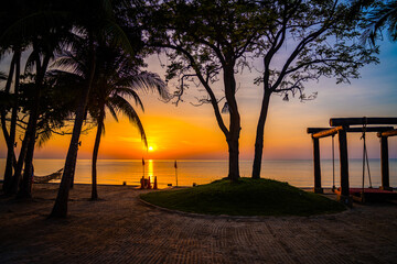 Beachfront sunrise with pool and palm trees in Hua Hin, Prachuap Khiri Khan, Thailand