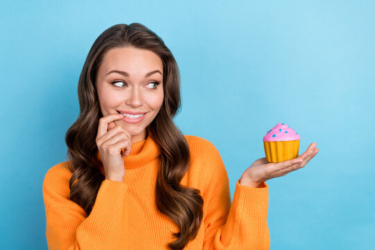 Photo of tricky cunning lady wear knitted pullover finger mouth holding hand arm small cupcake isolated blue color background
