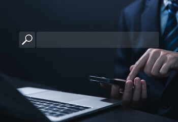 Businessman showing internet search in laptop	
