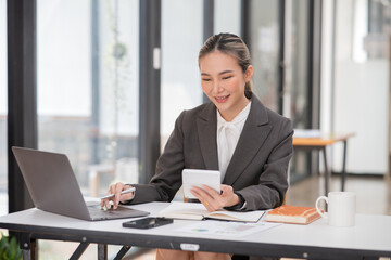 Asian businesswoman working on documents at office
