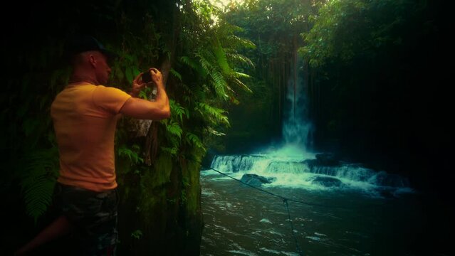 Active lifestyle travel people explore amazing waterfall hidden in tropical rainforest jungle on nature background 4K