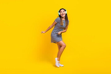 Full body size photo cadre of funky vietnamese lady dancing active motion party discotheque earphones isolated on yellow color background