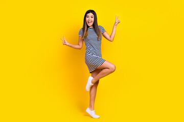 Fototapeta na wymiar Photo of overjoyed positive lady wear trendy clothes hand demonstrate v-sign good mood isolated on yellow color background