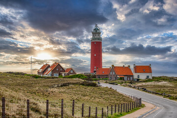 Lighthouse on the Wadden Island of Texel, Netherlands at sunset, dramatic sky - obrazy, fototapety, plakaty