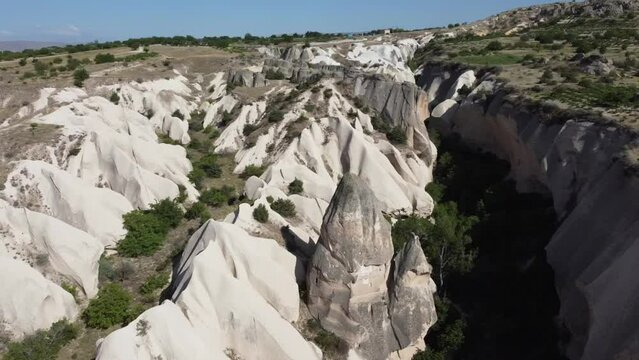 Drone circles a rock formation, a troglodyte dwelling in Red Rose Valley, Cappadocia, Turkey