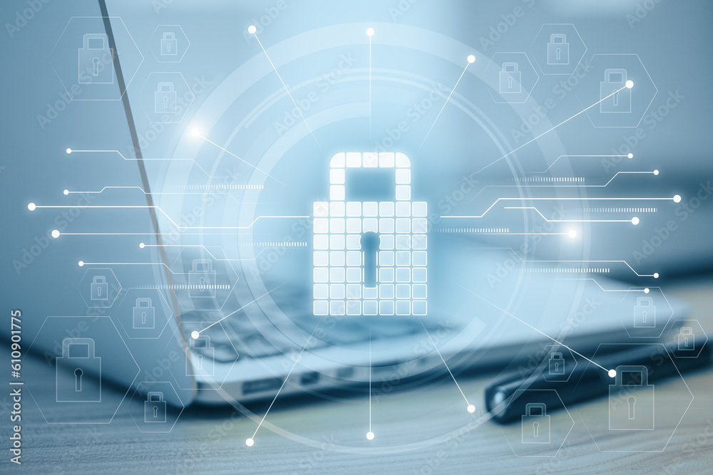 Poster Close up of laptop on desktop with glowing circuit padlock hologram on blurry background. Secure and safety concept. Double exposure.