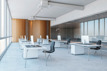 Side view on minimalistic style workspace white tables with modern computers on concrete floor in open space office with wooden and glass partitions walls background. 3D rendering