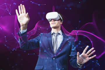 Attractive young businessman with VR glasses on creative glowing purple metaverse space background. Abstract world and innovation concept.