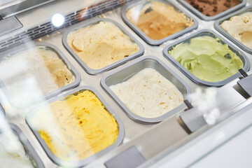 Flavors various ice cream in Rome, Italy. A variety of sugar-free vegan ice cream with natural ingredients on display at the gelateria. Italian gelateria. Assortment of colorful gelato on cafe