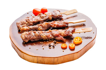Grilled beef steak on wooden board with tomatoes isolated on white background.