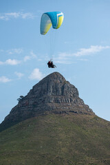 Fototapeta na wymiar paraglider over the mountains. flying over lion's head