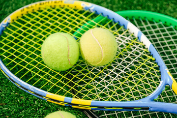Tennis rackets and tennis balls. Tennis equipment on the tennis court. Sports, tennis and a green court.