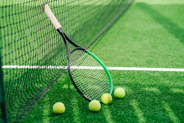 Tennis rackets and tennis balls. Tennis equipment on the tennis court. Sports, tennis and a green...