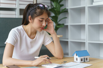 Woman doing finance at home office with calculate expenses and savings. Saving money and finances concept