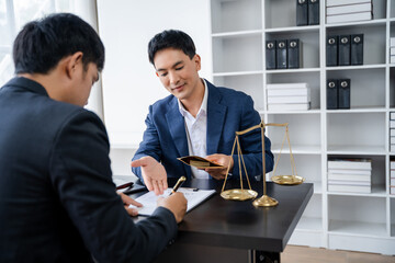 Legal counsel presents to the client a signed contract with legal law. justice and lawyer concept in office.