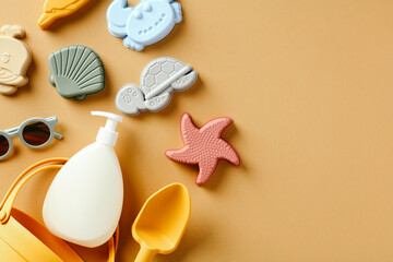 Silicone beach toys for kids and suntan lotion on beige background. Flat lay. Top view.