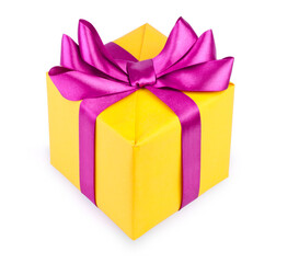 Yellow gift box with purple ribbon bow isolated on white background.