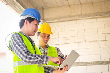 Engineers and builders having a planning meeting on a construction site. construction industry...