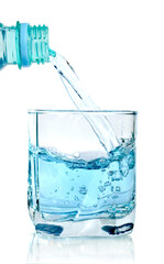 clear water being poured into a glass cup isolated on white background