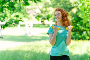 tired woman doing exercises  with Dumbbells in public park    Fitness, sport and exercise concept