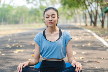 Fototapeta na wymiar Fitness Asian woman doing yoga in park and jogging at city park in summer morning. Healthy female athlete enjoy outdoor sport training workout exercise and running, Healthy and happy women concept.