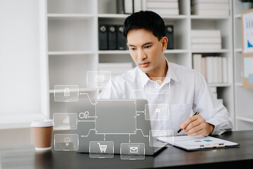  Businessman working with laptop computer and smart phone on desk in office with virtual icon diagram.