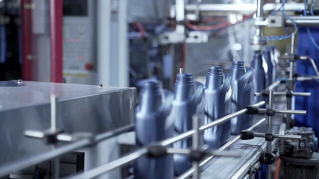manufacturing of plastic canister for automobile industry. canister bottles moving through the industrial conveyor belt