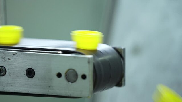 Close up of Plastic bottle cap Manufacturing in a automatic machine.
