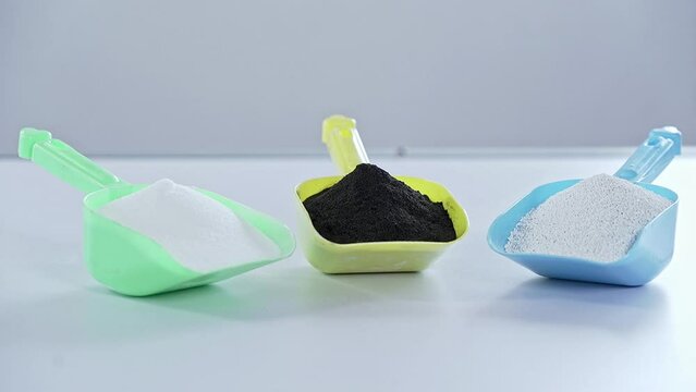 Pile of plastic grains in spoon close up.