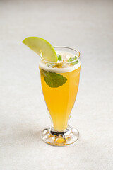 Glass of refreshing iced tea with mint and apple
