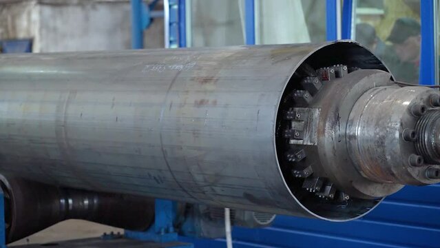 Pipe manufacturing plant. Pipe plant. Iron pipe welding. Pipe expansion. Sparks of welding. Tap. Factory. Machine tools. Production. Heavy industry.