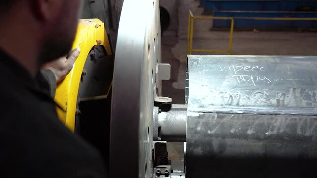 Pipe manufacturing plant. Pipe plant. Iron pipe welding. Pipe expansion. Sparks of welding. Tap. Factory. Machine tools. Production. Heavy industry.