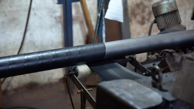 Pipe manufacturing plant. Pipe plant. Iron pipe welding. Pipe expansion. Sparks of welding. Tap. Factory. Machine tools. Production. Heavy industry.
