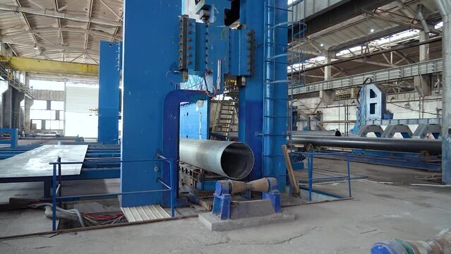 Pipe manufacturing plant. Pipe plant. Iron pipe welding. Pipe expansion. Sparks of welding. Tap. Factory. Machine tools. Production. Heavy industry.