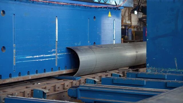 Pipe manufacturing plant. Pipe plant. Iron pipe welding. Pipe expansion. Sparks of welding. Tap. Factory. Machine tools. Production. Heavy industry.